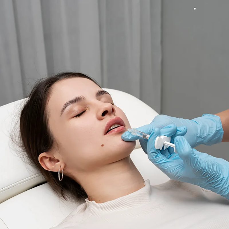 high-angle-woman-getting-lip-fillers-clinic